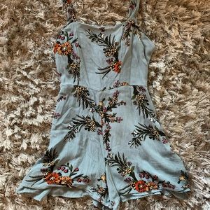 Blue shorts jumper with yellow and orange flowers.